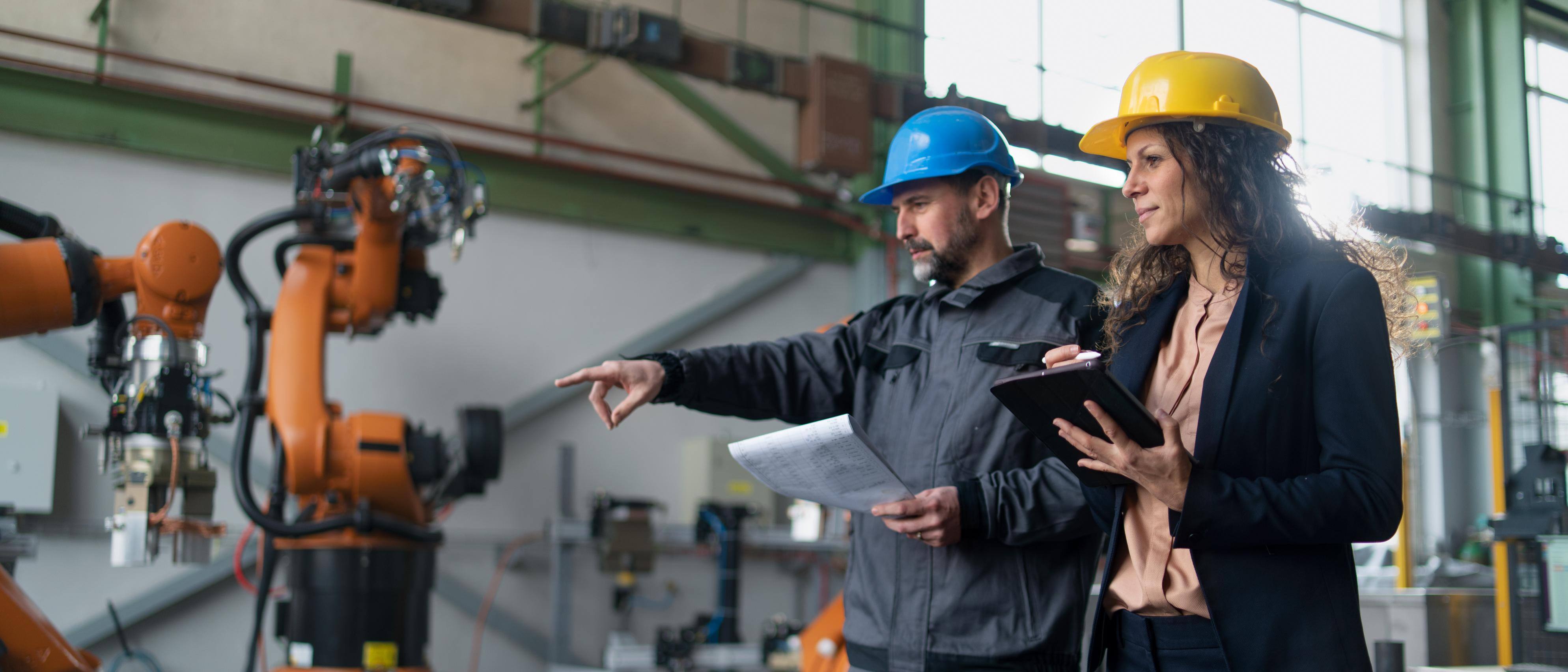two factory workers assessing equipment calibration